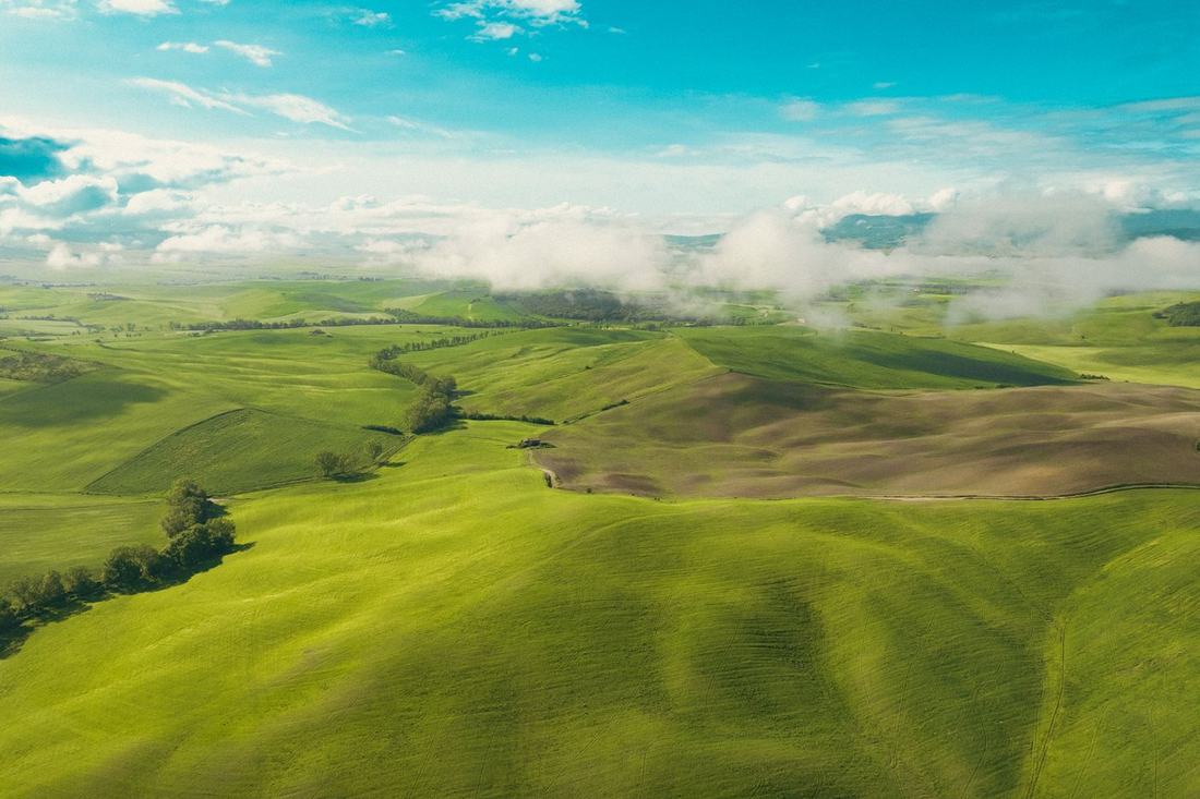 Rolling green hills with low clouds