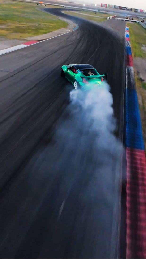 Top-down FPV view of a drift car trailing smoke