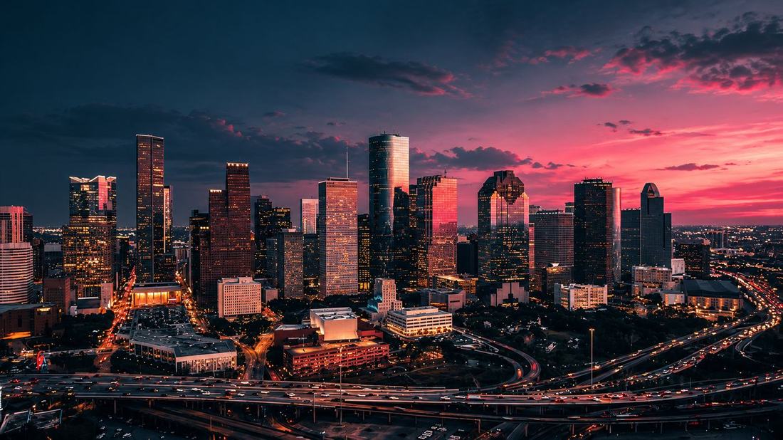 Houston skyline at dusk from above with lit freeways